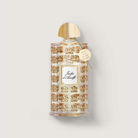 bottle of jardin d'amalfi with gold lid, gold embossed repeated pattern of the fleur de lis and medallion