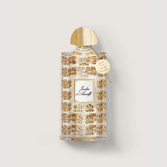 bottle of jardin d'amalfi with gold lid, gold embossed repeated pattern of the fleur de lis and medallion