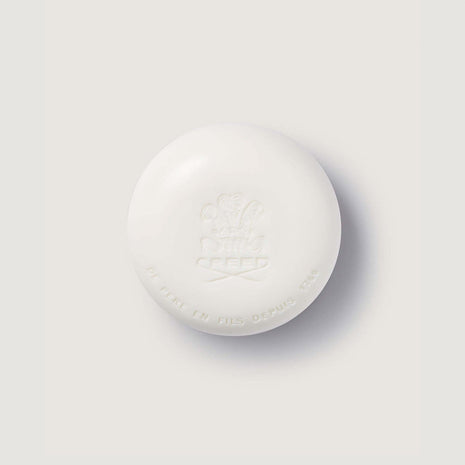 round soap bar with creed logo imprinted on the surface